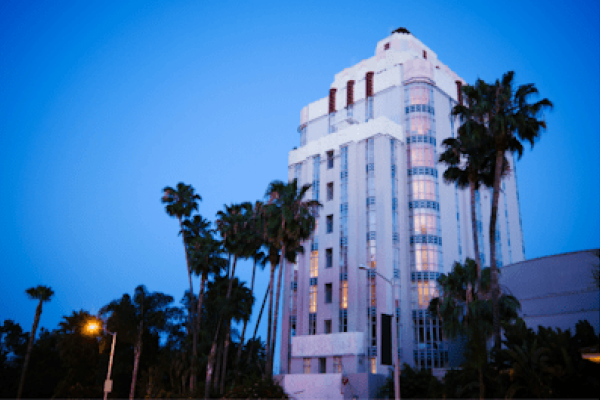 Sunset Tower and palm trees in evening in West Hollywood, CA